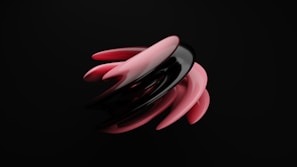 A dynamic, abstract sculpture composed of sleek, curved shapes in black and pink, contrasting sharply against a solid black background. The design features a smooth, glossy texture, creating an interplay of light and shadow that gives the shapes a sense of fluid motion.