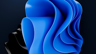 An abstract design featuring smooth, flowing curves primarily in blue and black, creating a sense of depth and movement.