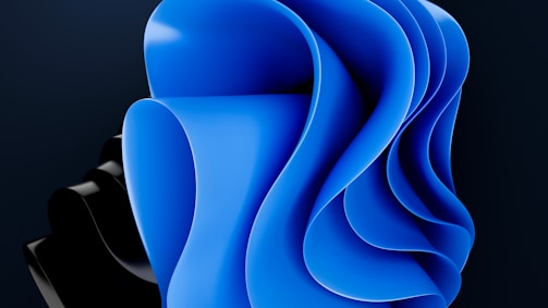 An abstract design featuring smooth, flowing curves primarily in blue and black, creating a sense of depth and movement.