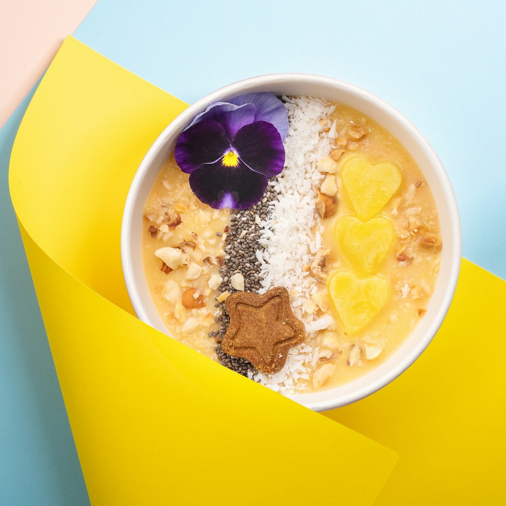 a bowl of oatmeal with a flower on top