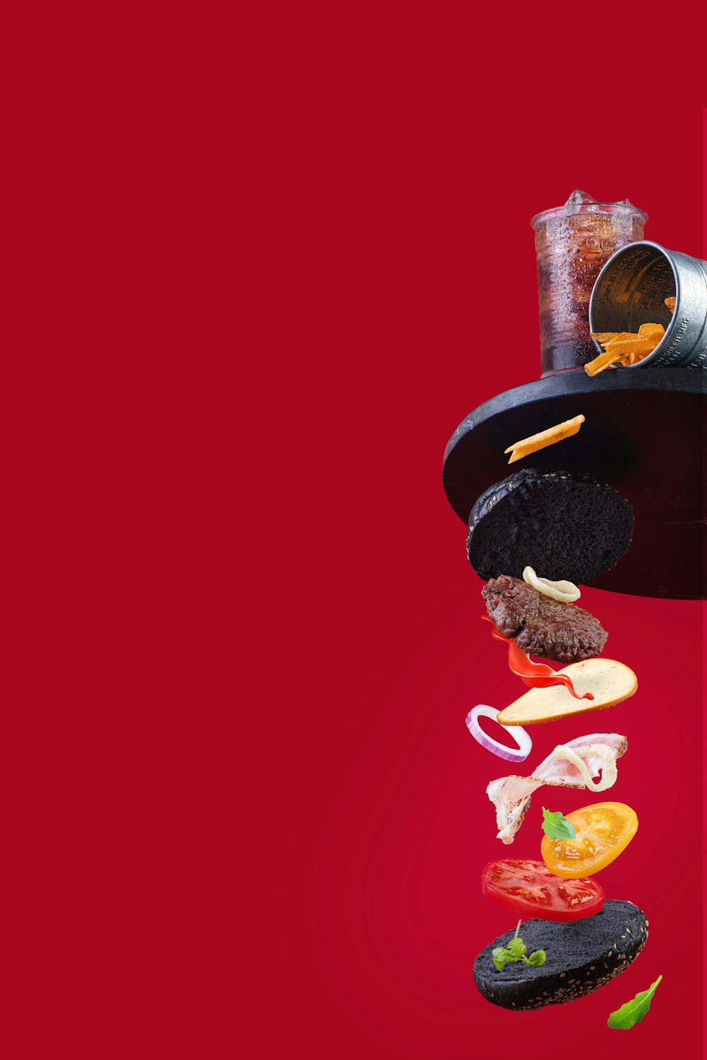 a red background with a hamburger falling into the air