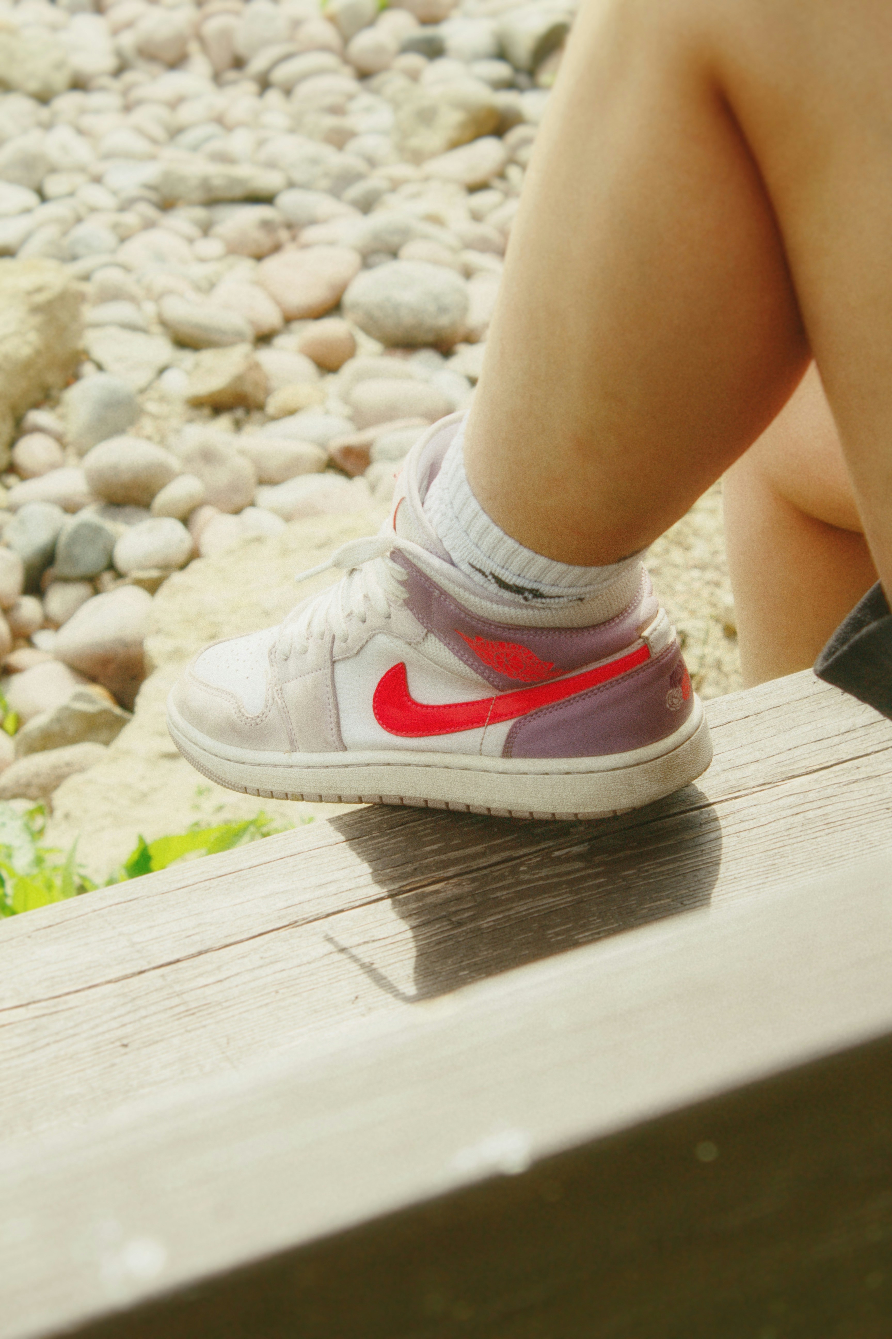 a person sitting on a bench with their legs crossed