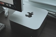 an apple computer sitting on top of a wooden desk