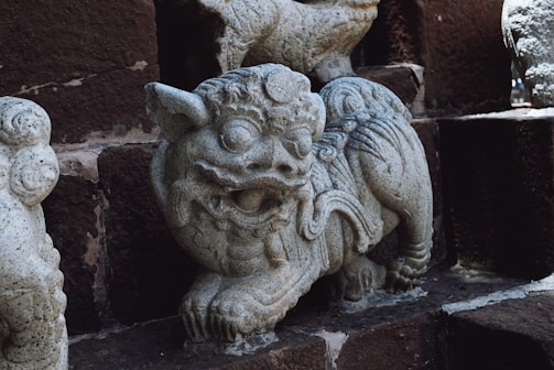 A carved stone statue of a mythical creature from ancient folklore.