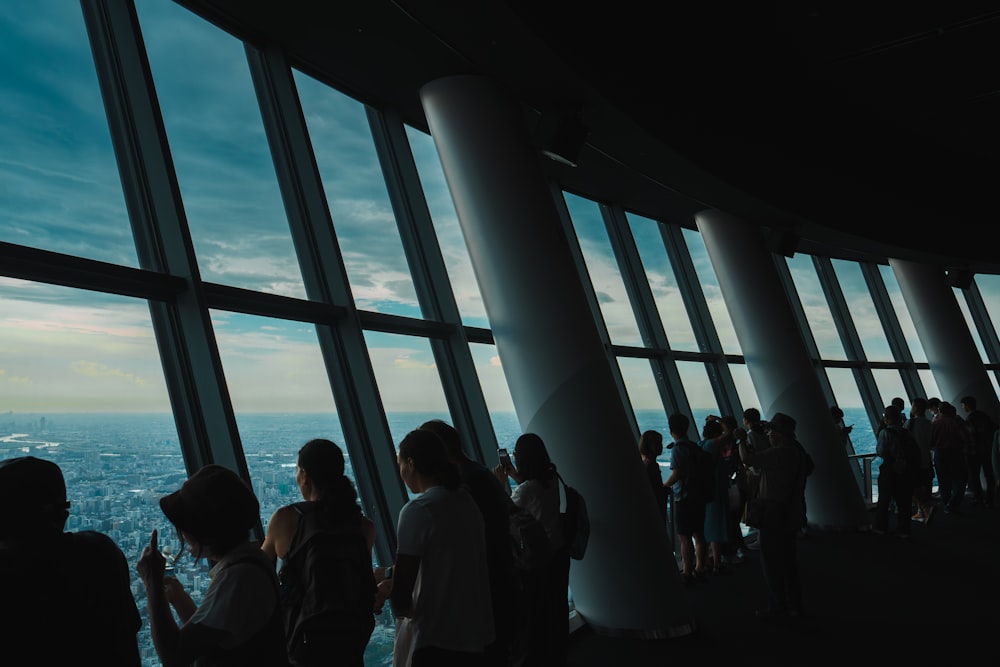 a group of people standing in front of a window