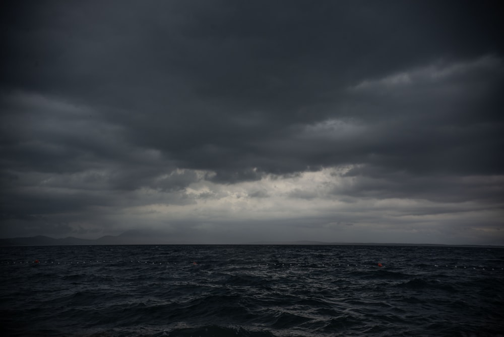 a large body of water under a cloudy sky