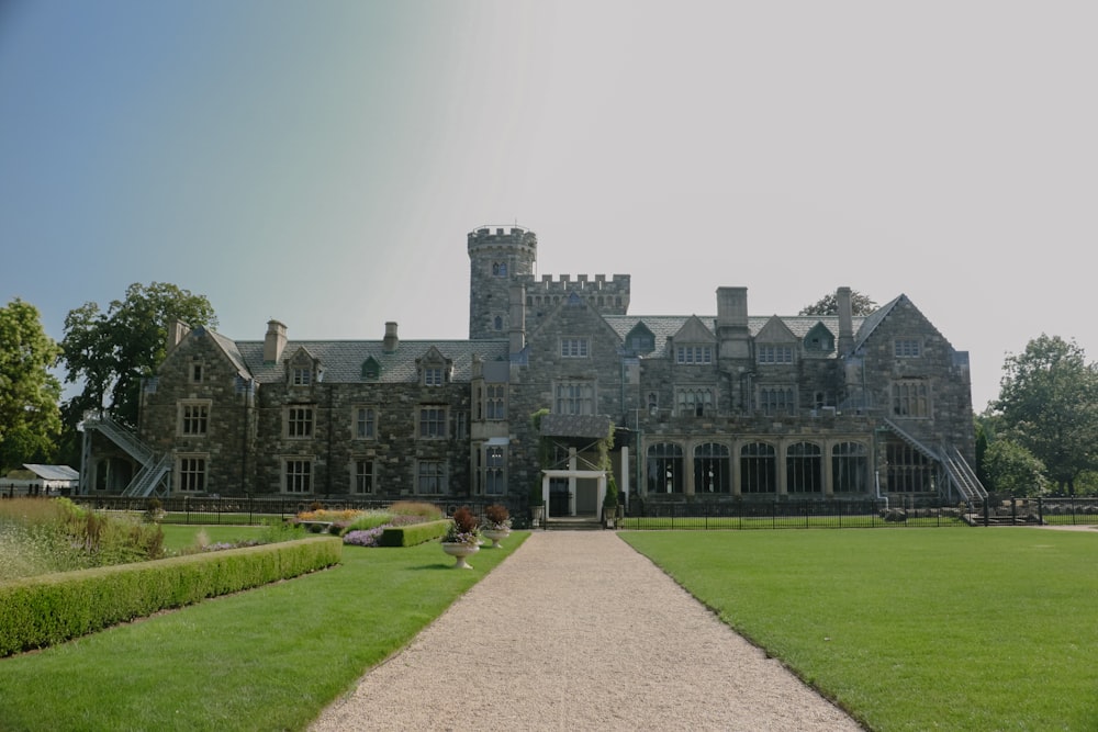 a large stone building with a walkway leading to it