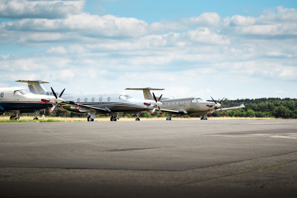 two airplanes are parked on the runway at the airport