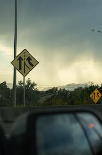 A learner driver practicing highway merging with a driving instructor beside them.