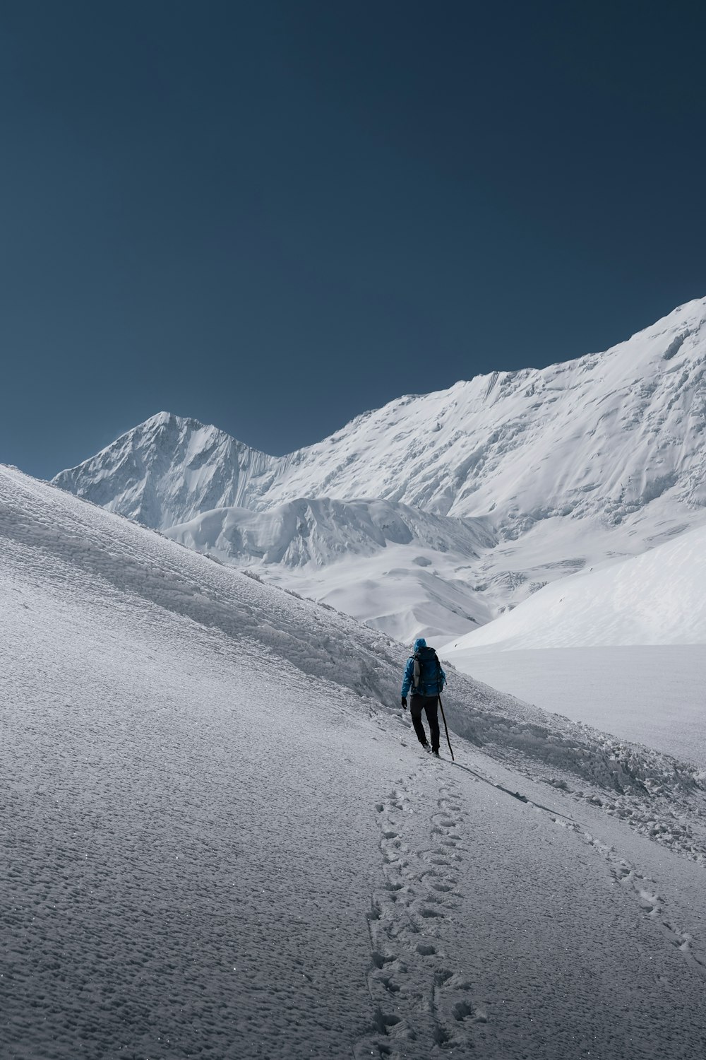 a person walking up a snow covered hill