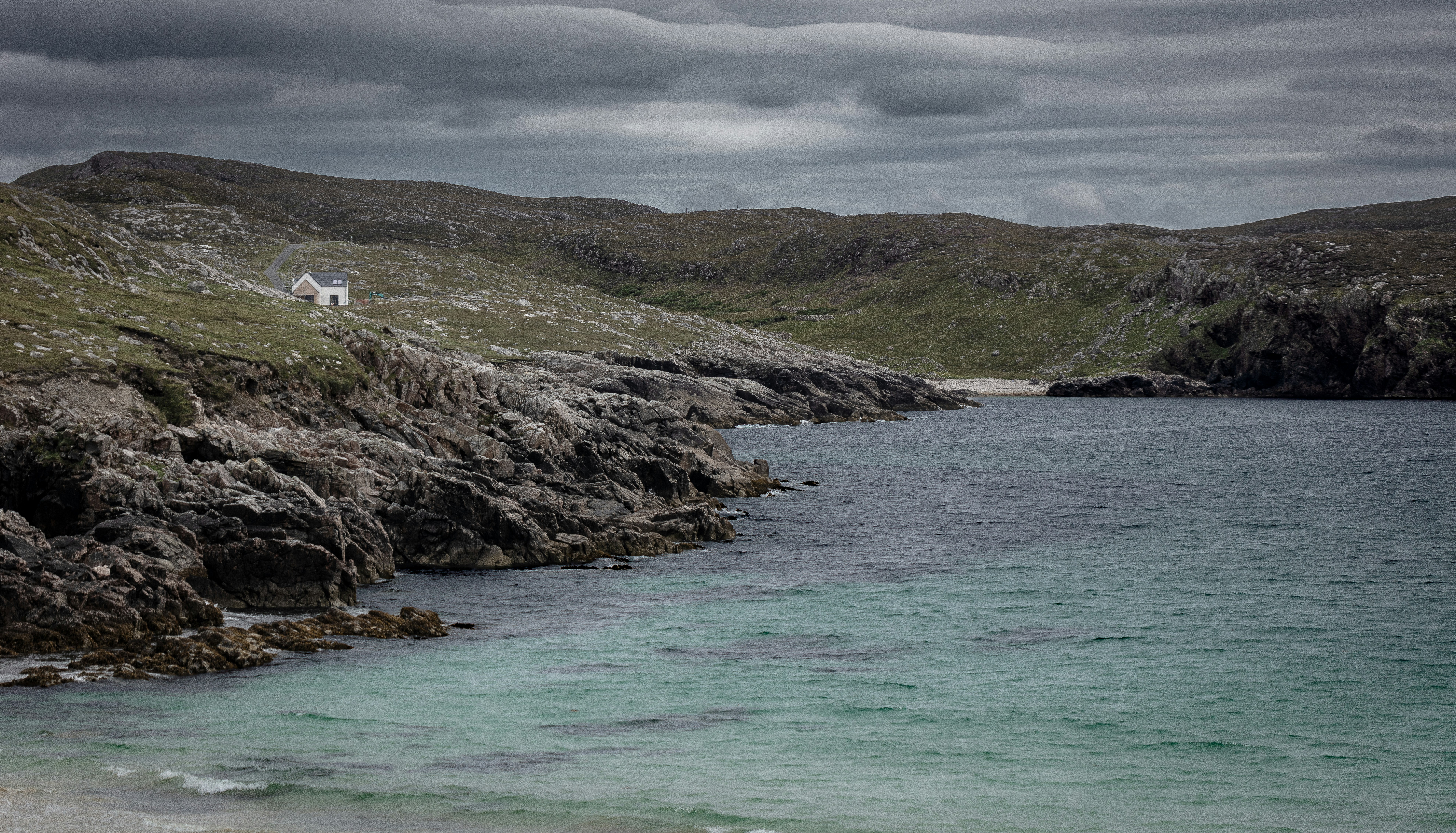 a body of water near a rocky shore, 