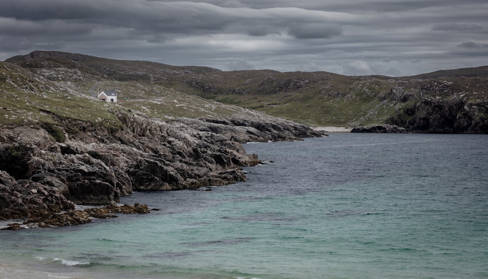 a body of water near a rocky shore