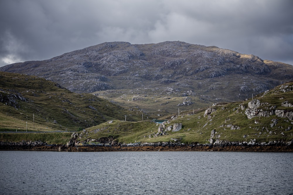 a body of water with a mountain in the background