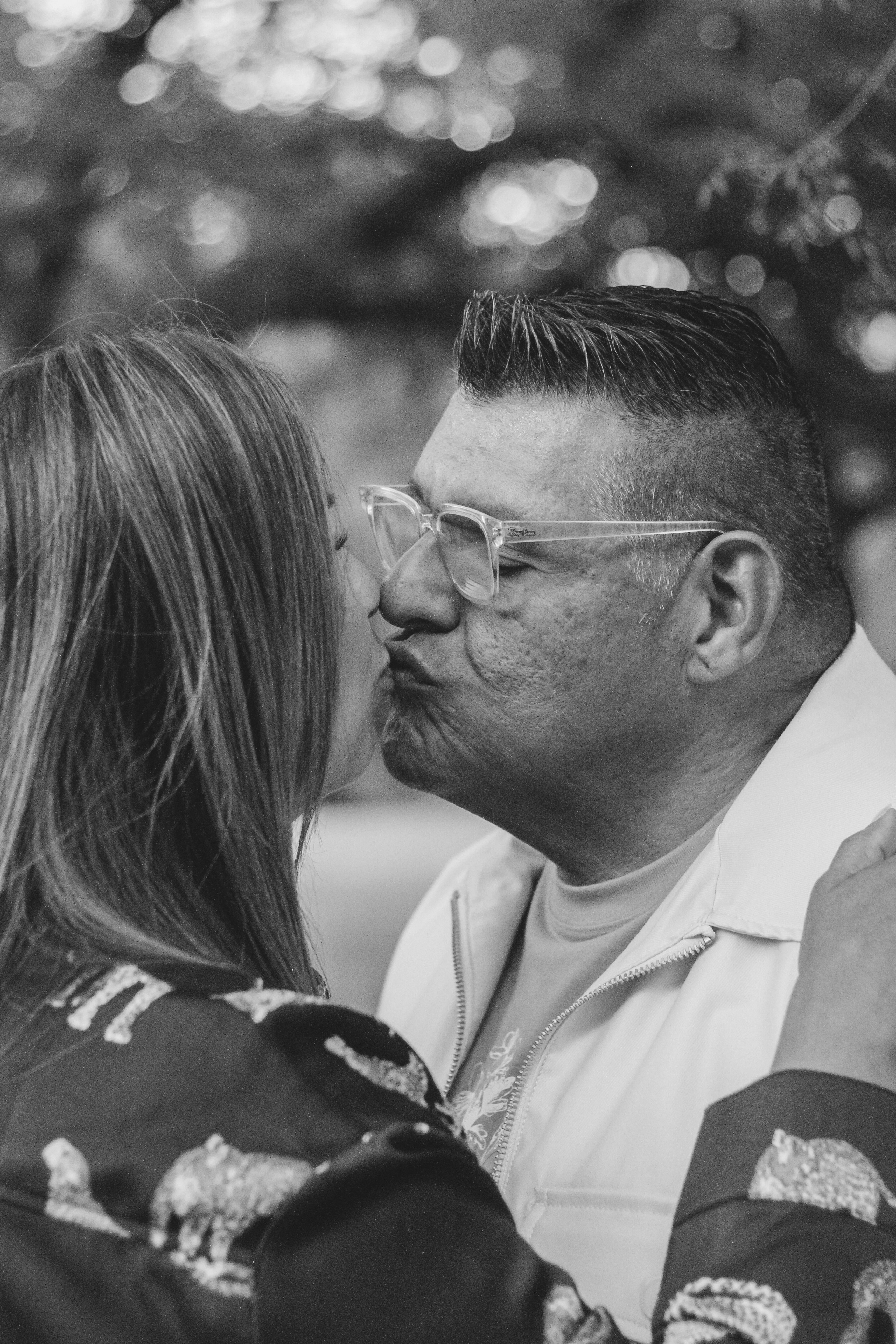 Black and white portrait of a couple sharing a tender moment, soft natural light, genuine intimacy and warmth