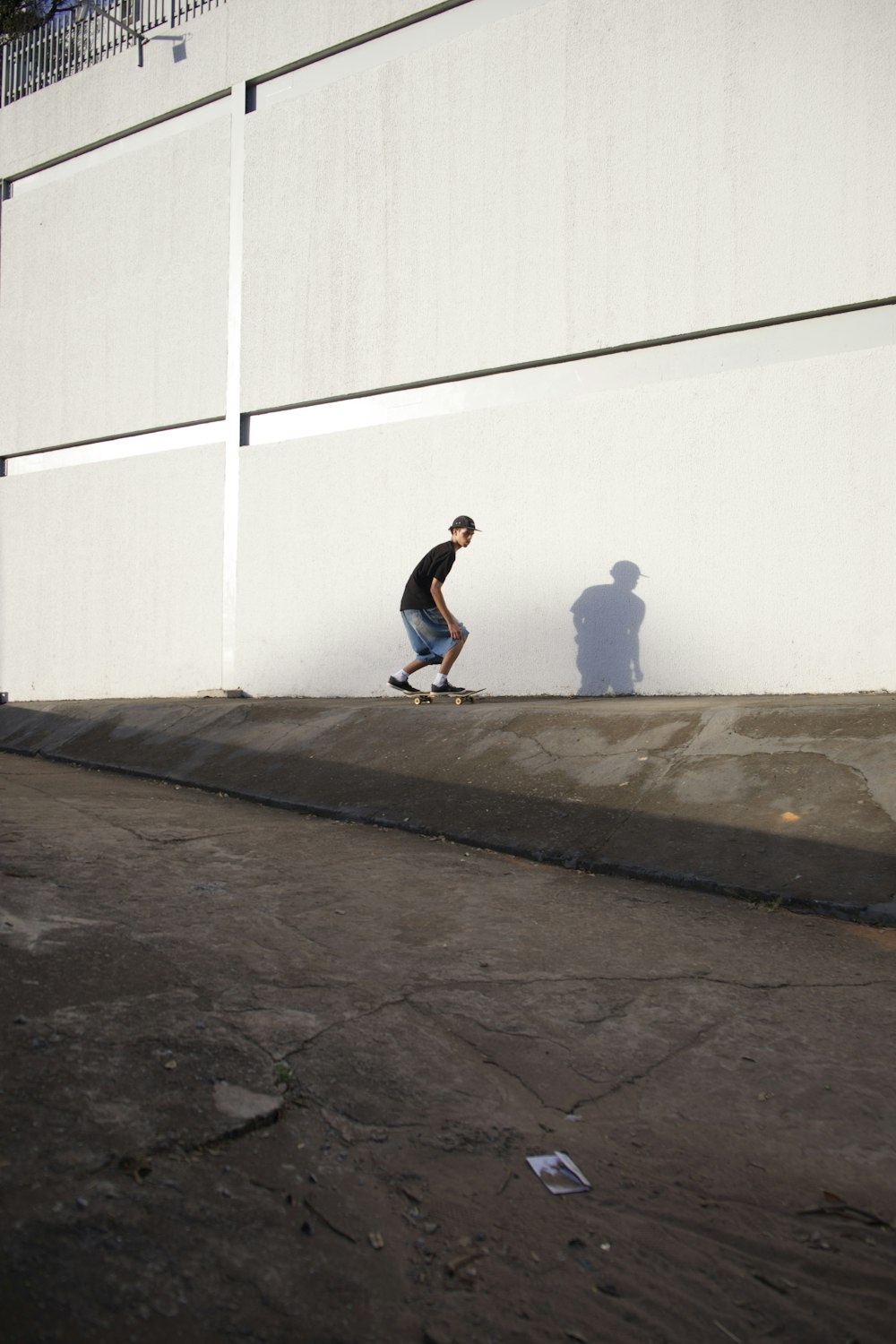 a man riding a skateboard down the side of a road