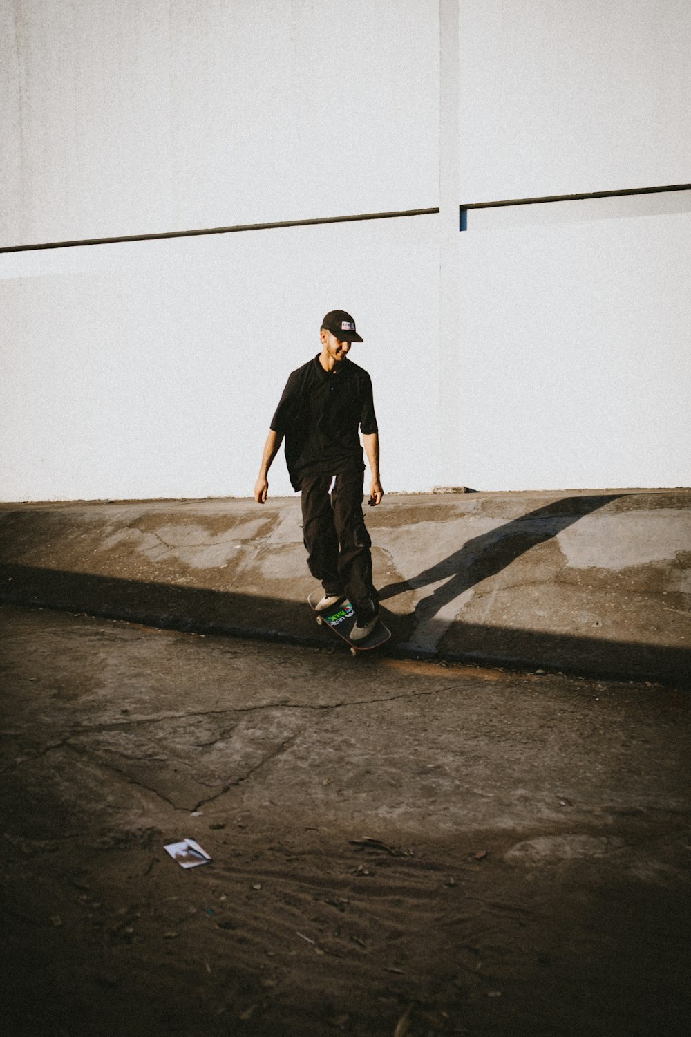 a man riding a skateboard down the side of a road