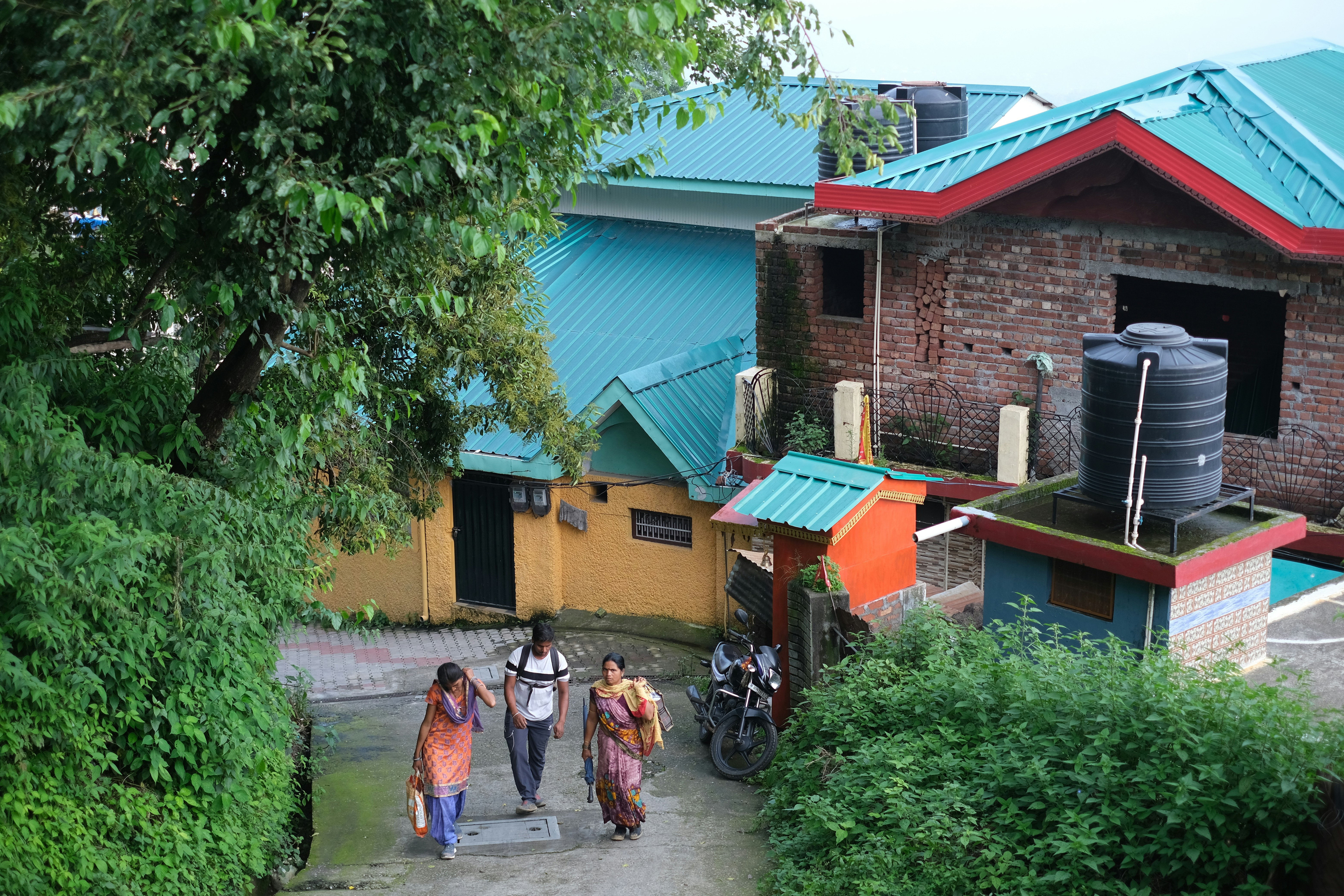 a group of people walking down a dirt road