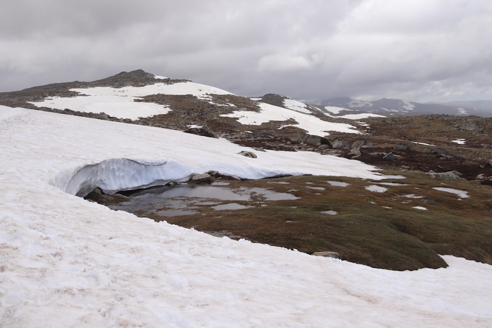 a snow covered mountain with a hole in the middle