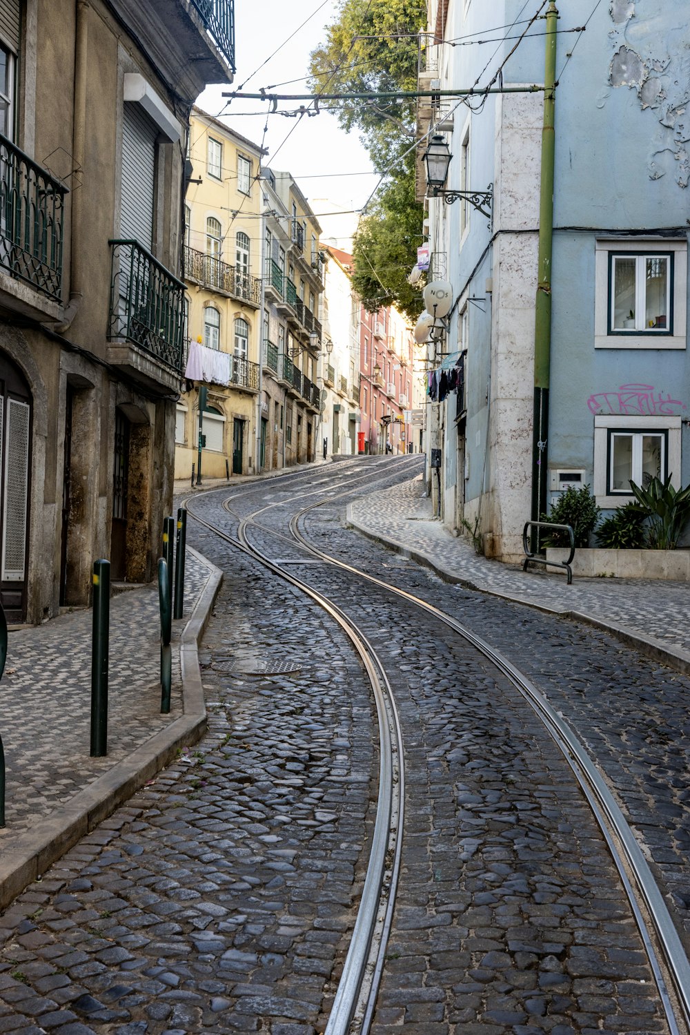 a cobblestone street with a train track running through it