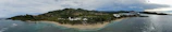 A panoramic shot of a tropical island seen from the cruise deck.
