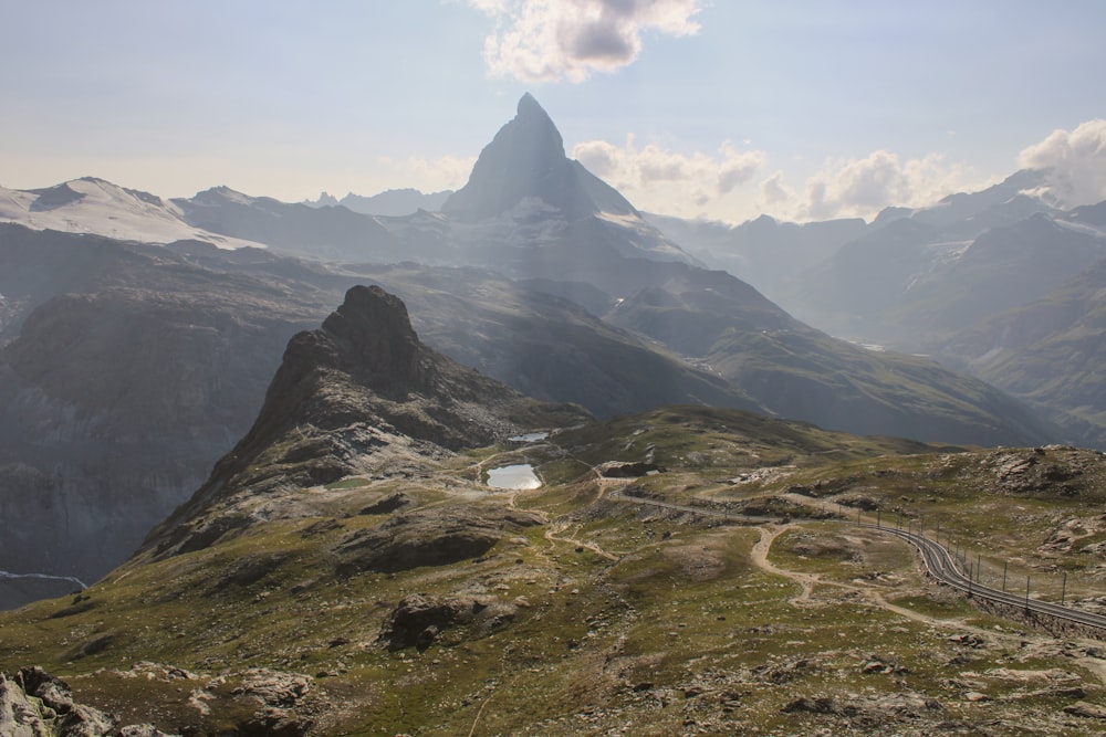 a view of a mountain range with a road going through it