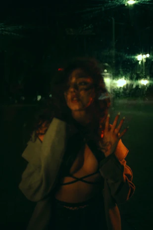 A shadowy figure in a sharp suit stands beneath a flickering streetlamp, hinting at Italian mafia secrets.