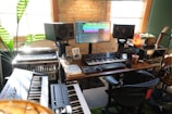 A cozy music studio corner with mixing equipment and instruments