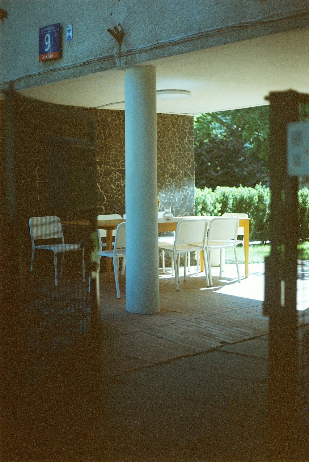 a group of chairs and tables sitting under a building