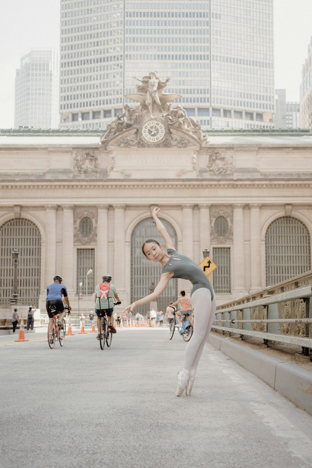 a woman in a leotard doing a trick on a skateboard