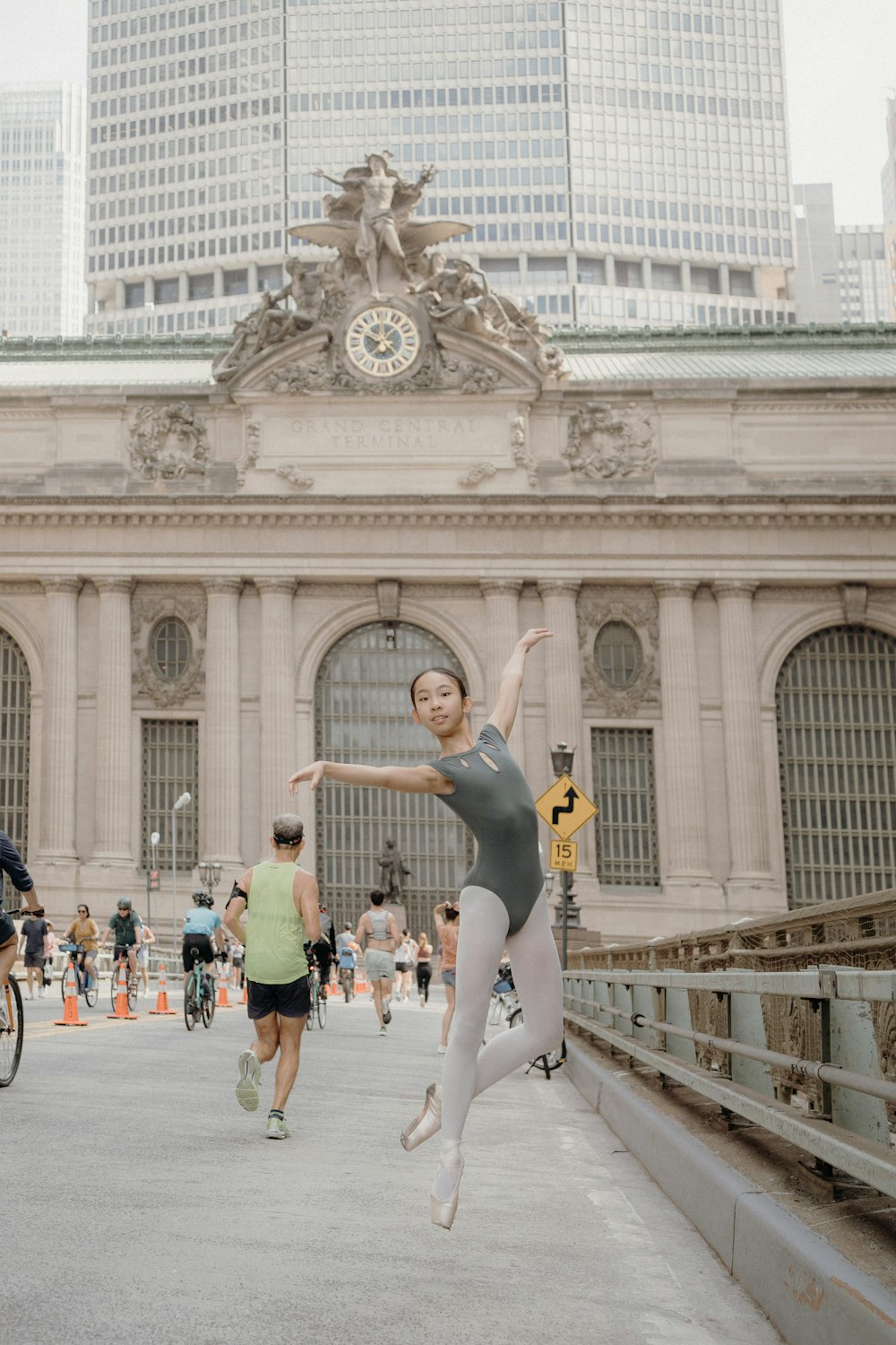 a woman jumping in the air in front of a building