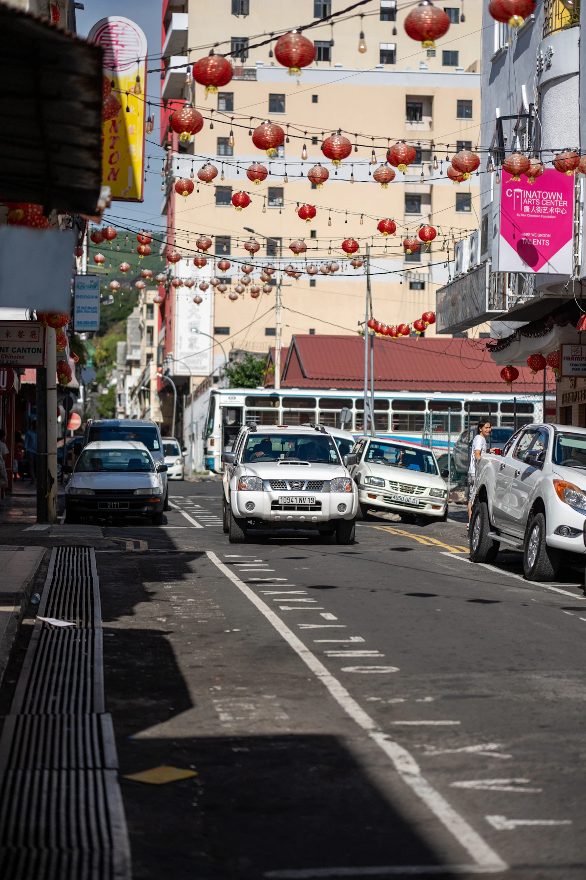 Lanterns hanging above a busy street in Port Louis Chinatown