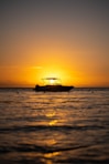 a boat is out on the water at sunset