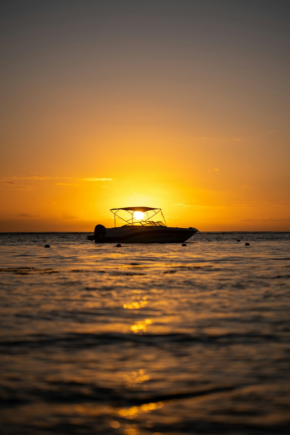 a boat is out on the water at sunset