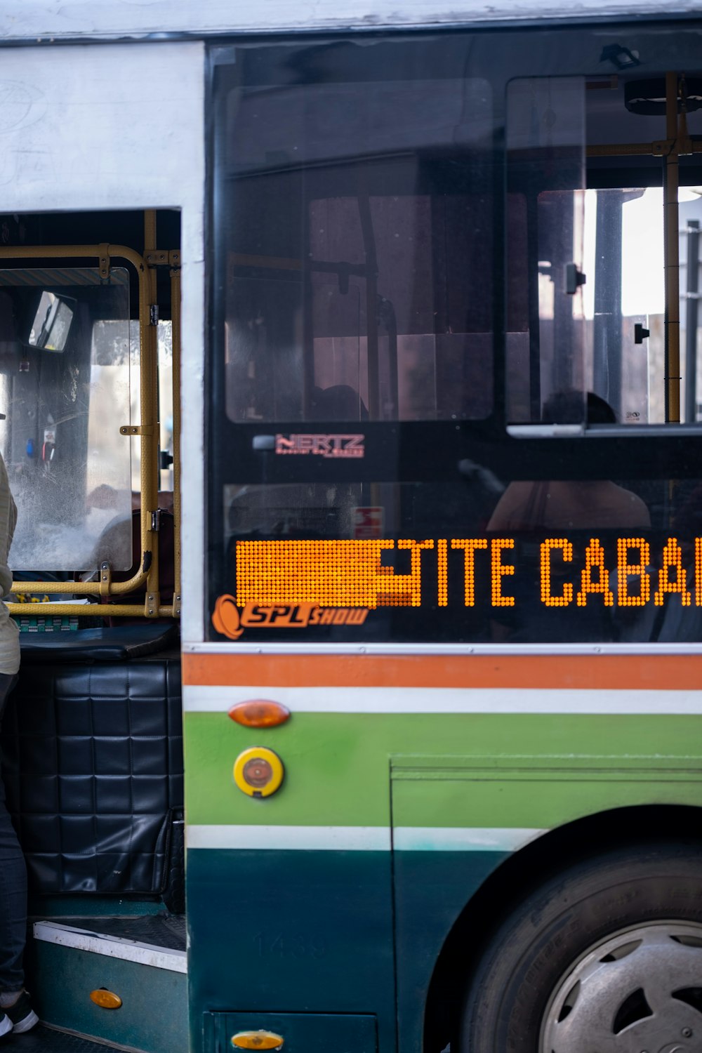 a man standing in the doorway of a bus