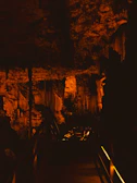 Mystical cave passageway softly illuminated by warm, ambient lighting.