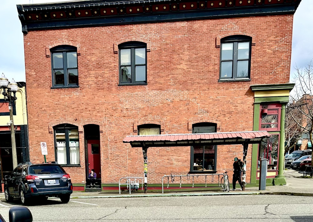 a car parked in front of a brick building