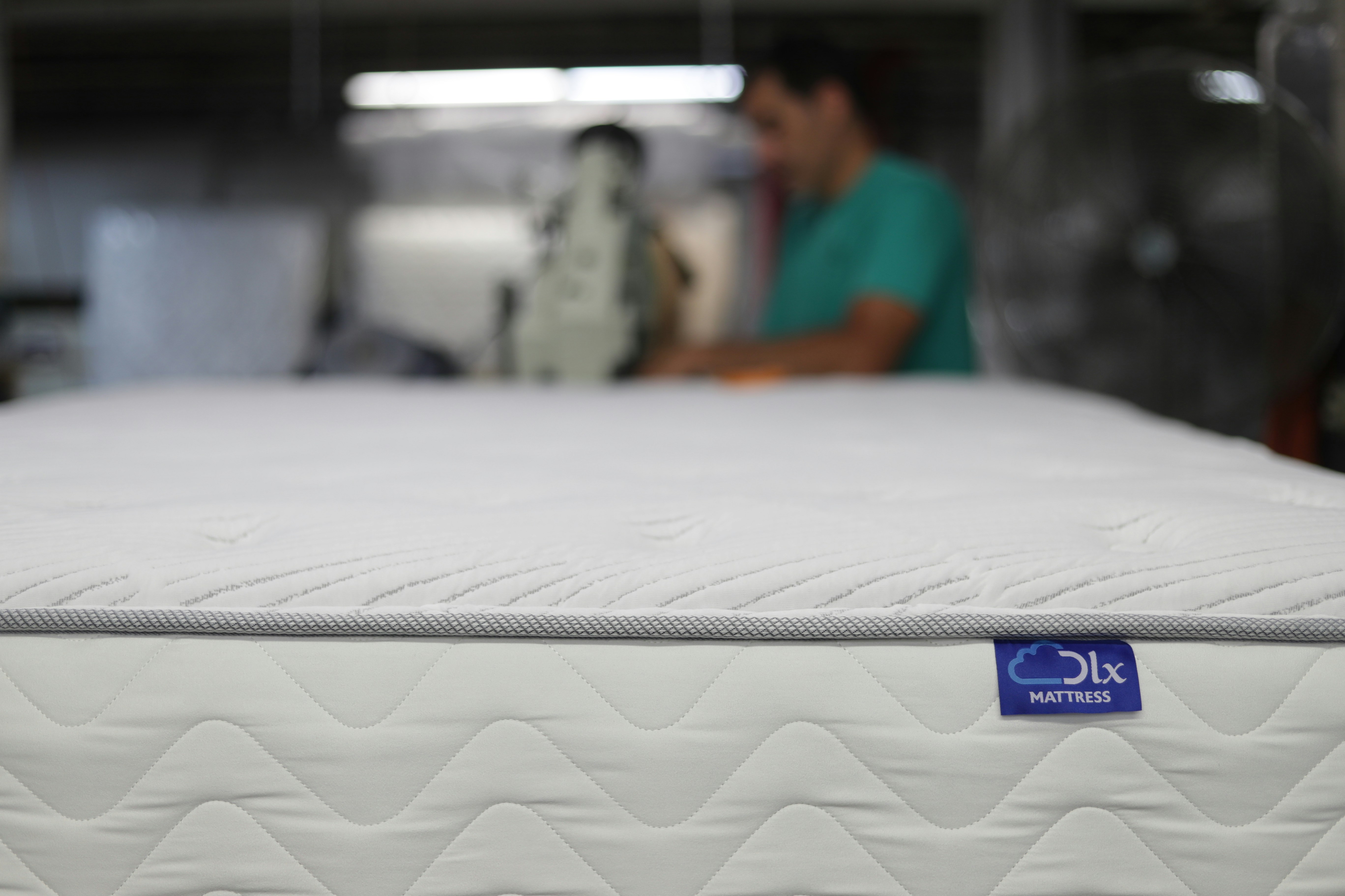 Tape edging in a mattress factory.