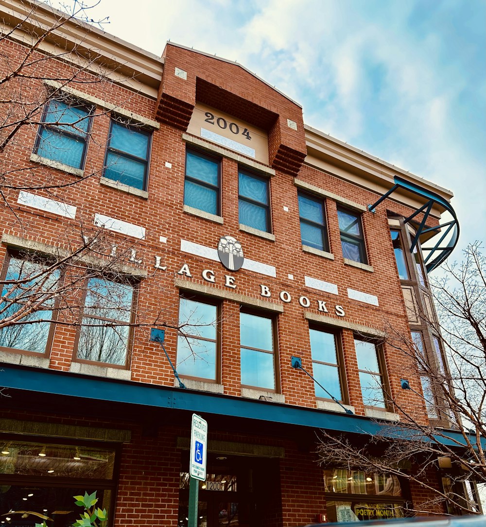 a tall brick building with a sign on the front of it