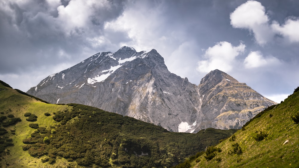 a view of a mountain range with clouds in the sky