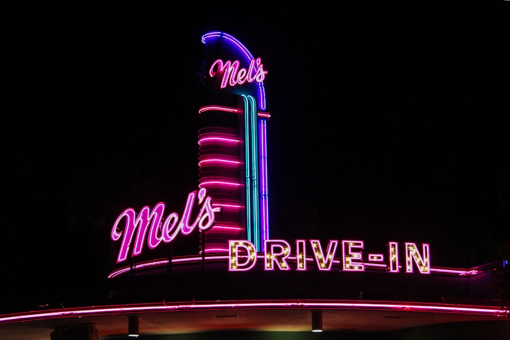 a neon sign that reads mel's drive - in