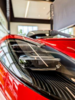 Overhead shot of a futuristic car showroom with red and black lighting
