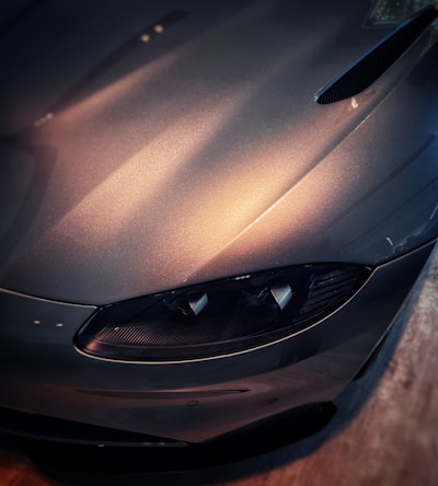 A stunning close-up of a gleaming car hood reflecting light.
