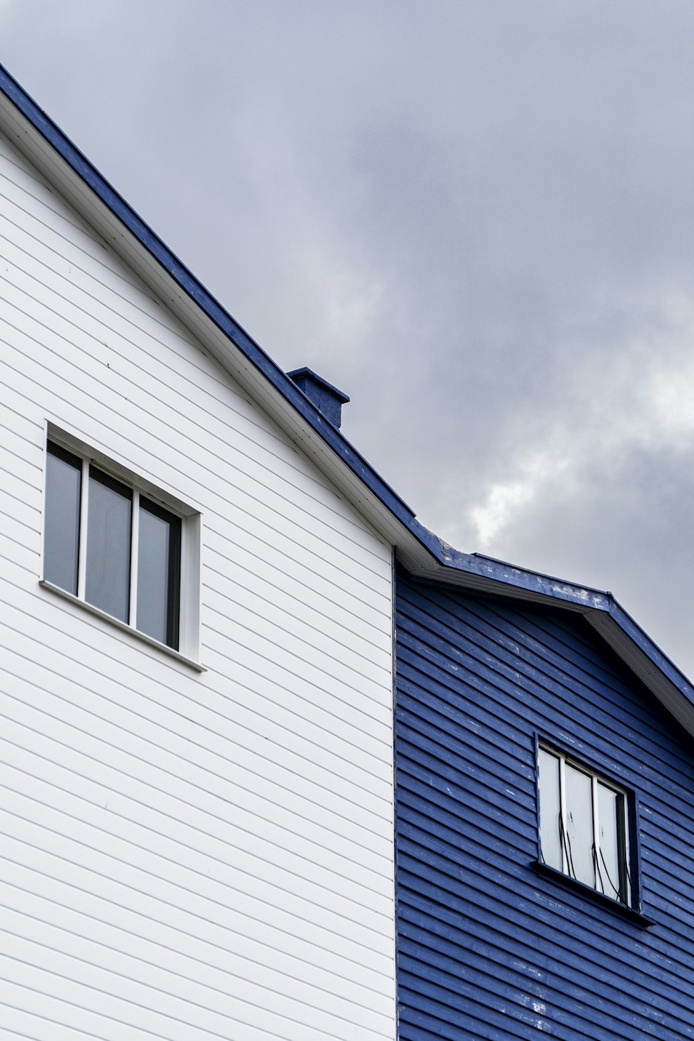 a blue and white house with a window