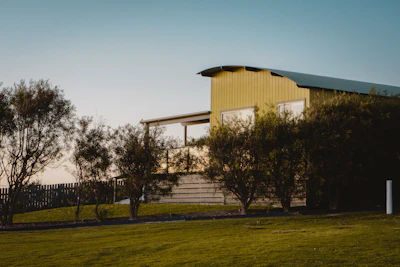 Wide shot of a house with a newly repaired zinc roof and clean gutters.