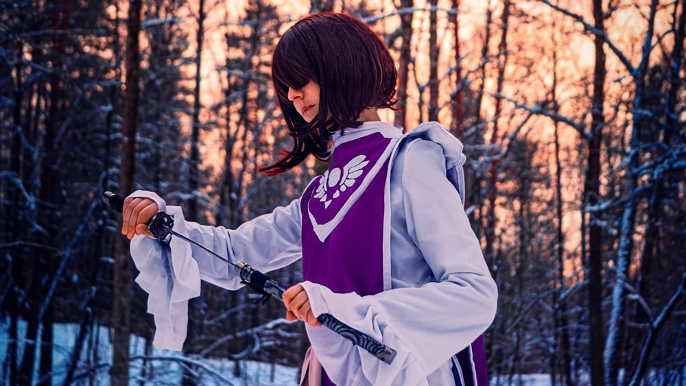 a woman in a purple and white outfit holding a pair of skis