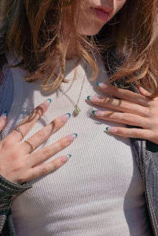 a close up of a woman with her hands on her chest