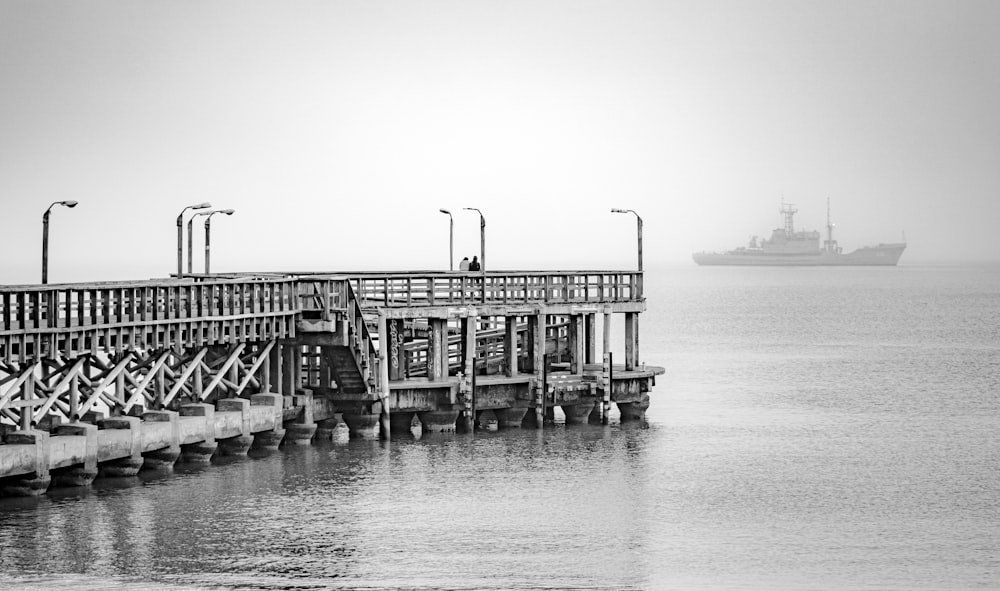 a boat is in the water near a pier