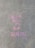 Pink chalk writing on a concrete pavement reads 'Dream until it's your reality.' The text appears artistic and slightly uneven against the rough texture of the sidewalk.
