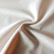 Close-up of colorful silky fabric gently folded in natural light.