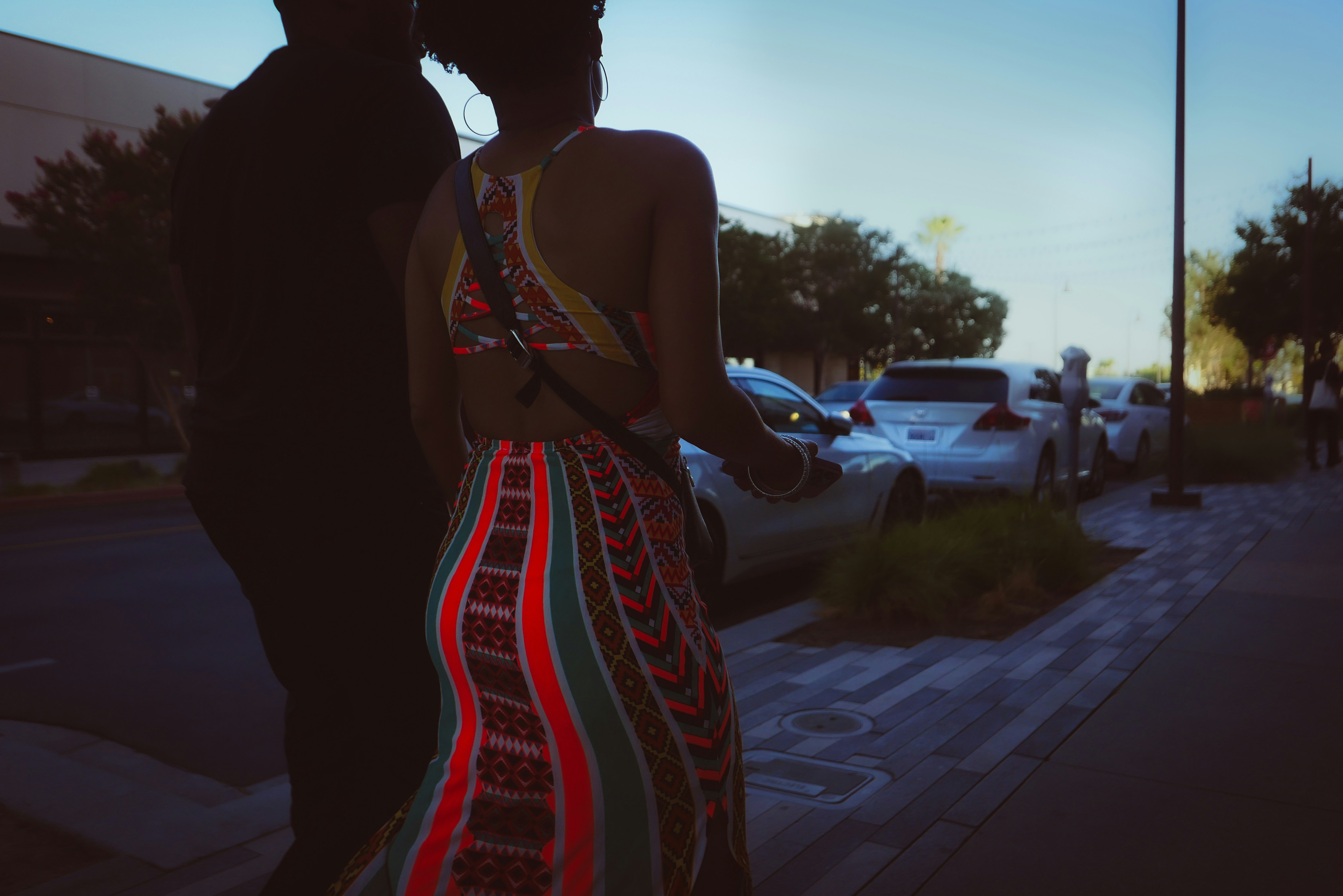 eine frau in einem bunten kleid, die neben einem mann steht